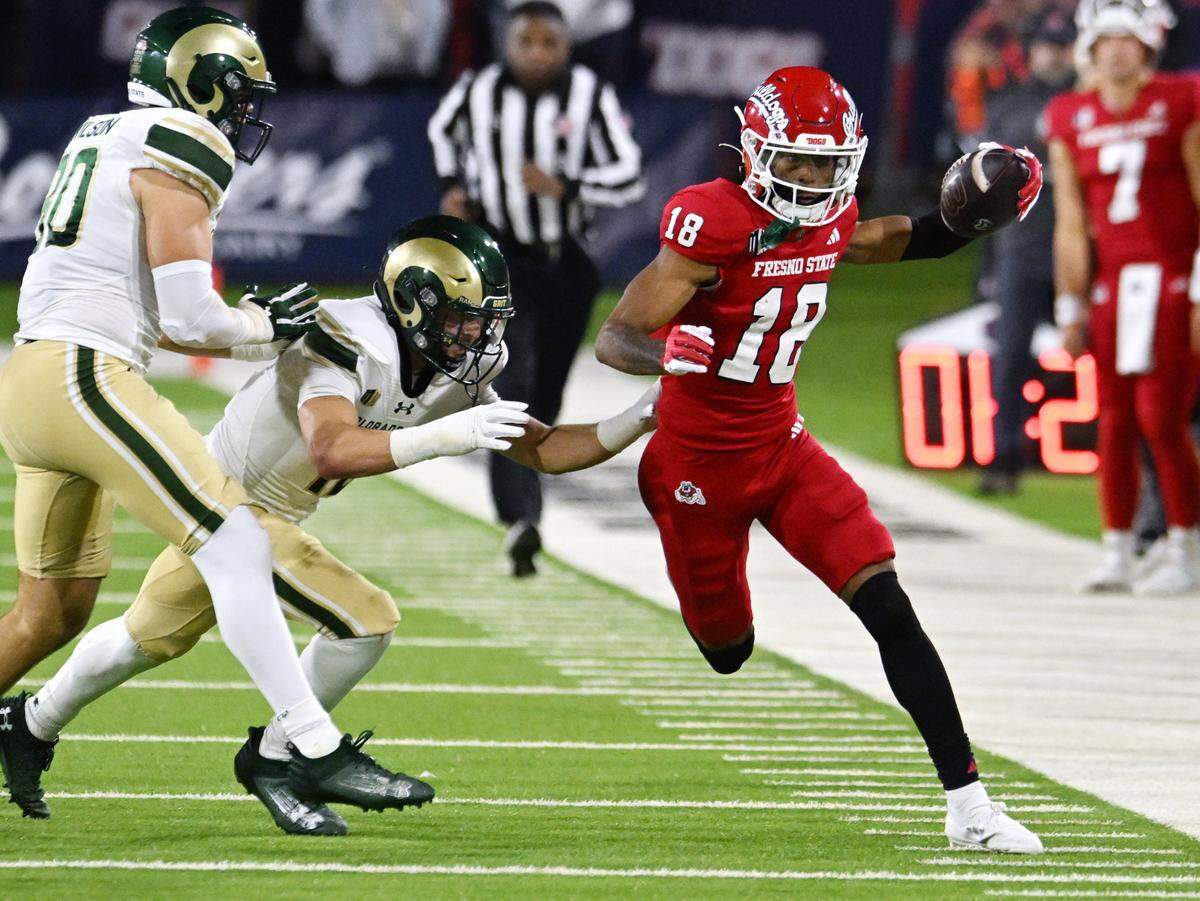 Fresno State’s Jalen Moss, right, is chased by Colorado State’s Jace Bellah, left, before being pushed out of bounds Saturday, Nov. 23, 2024 in Fresno.