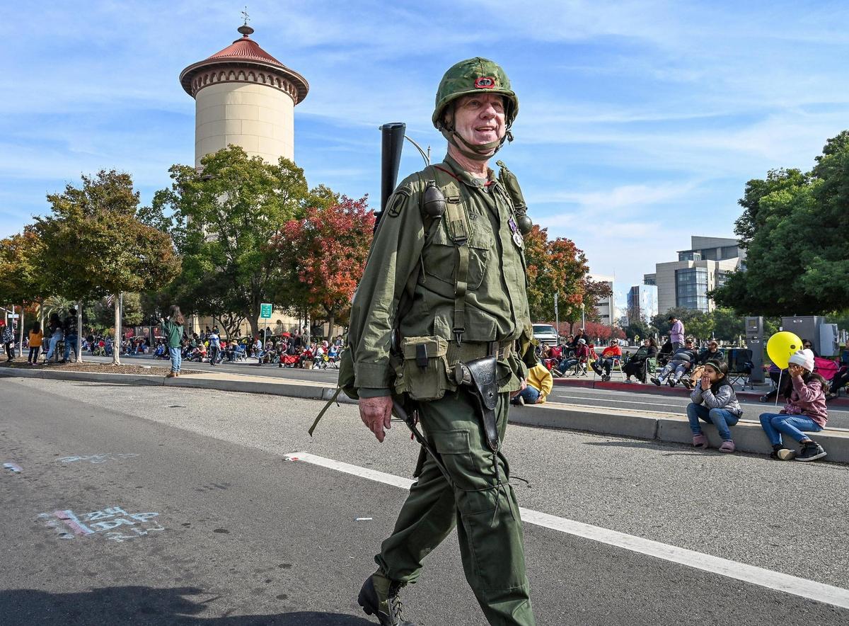 Army veteran Keith Hiler of Clovis marches in his military uniform near the Fresno Water Tower during the annual Veterans Parade in downtown Fresno on Friday, Nov. 11, 2022.