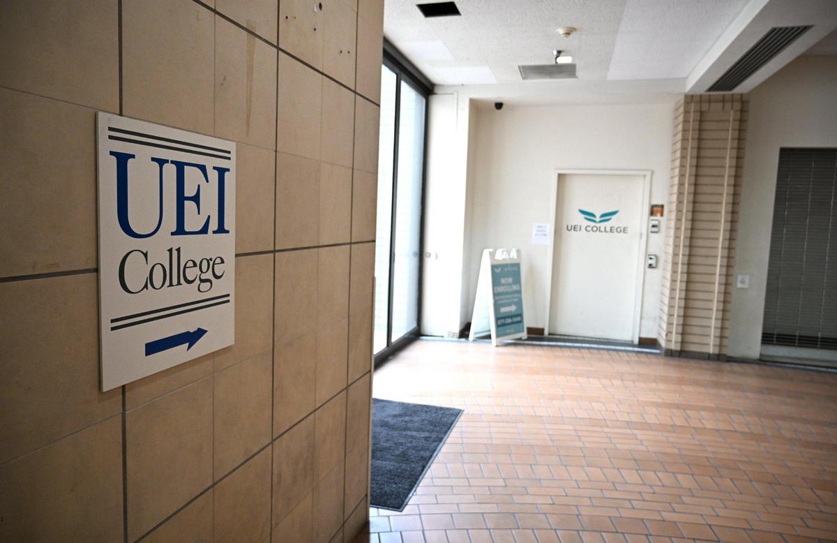 A sign on the wall at The New Manchester shopping center points to an elevator for UEI College Fresno, seen Friday, Jan. 31, 2025 in Fresno. Joshua Jones is part of a lawsuit against UEI College Fresno, a trade and vocational college, for failing to live up to its promises.