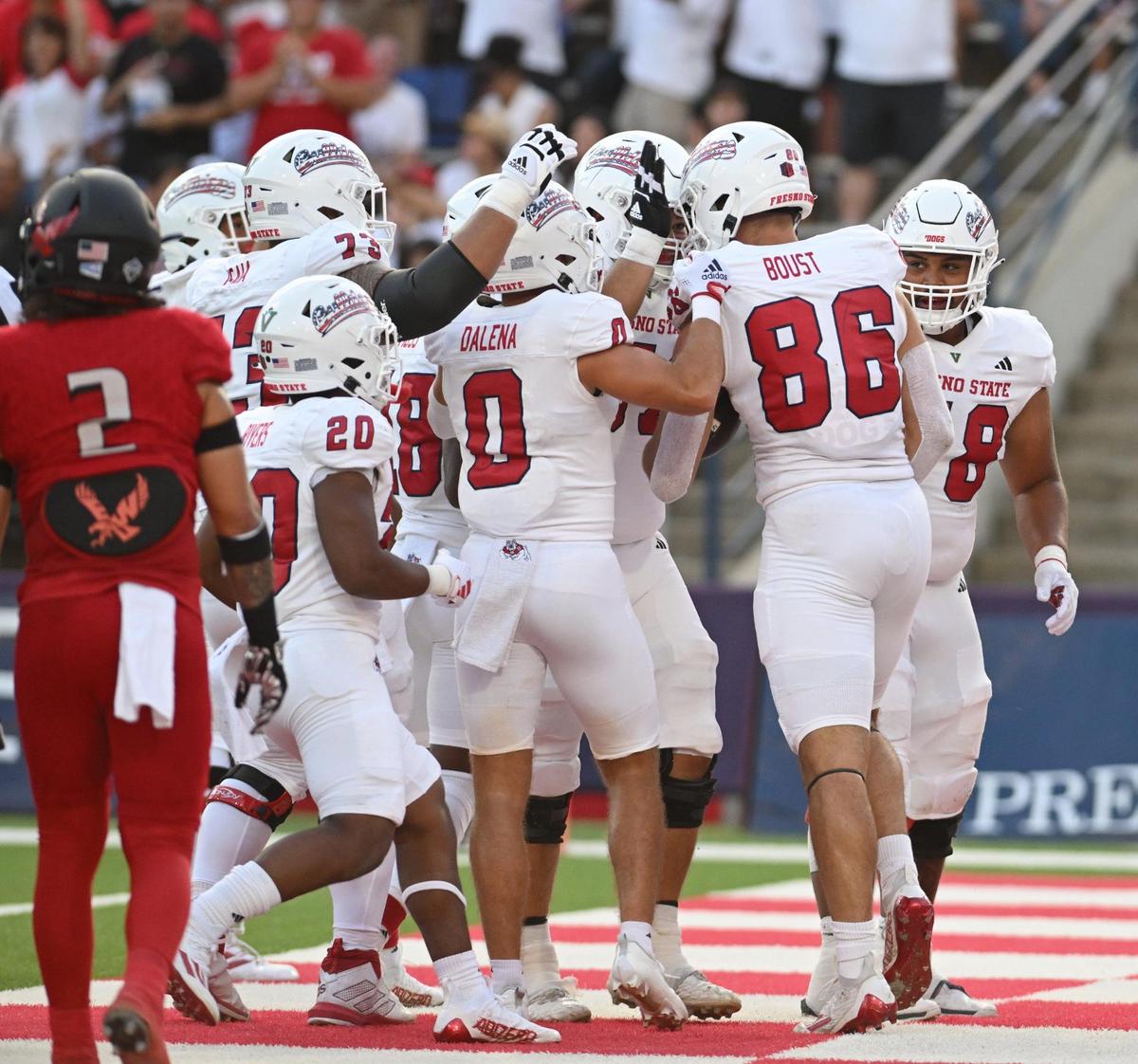 Fresno State players congratulate tight end Jake Boust, right, after catching a touchdown pass against Eastern Washington at Valley Children’s Stadium on Saturday, Sept. 9, 2023.