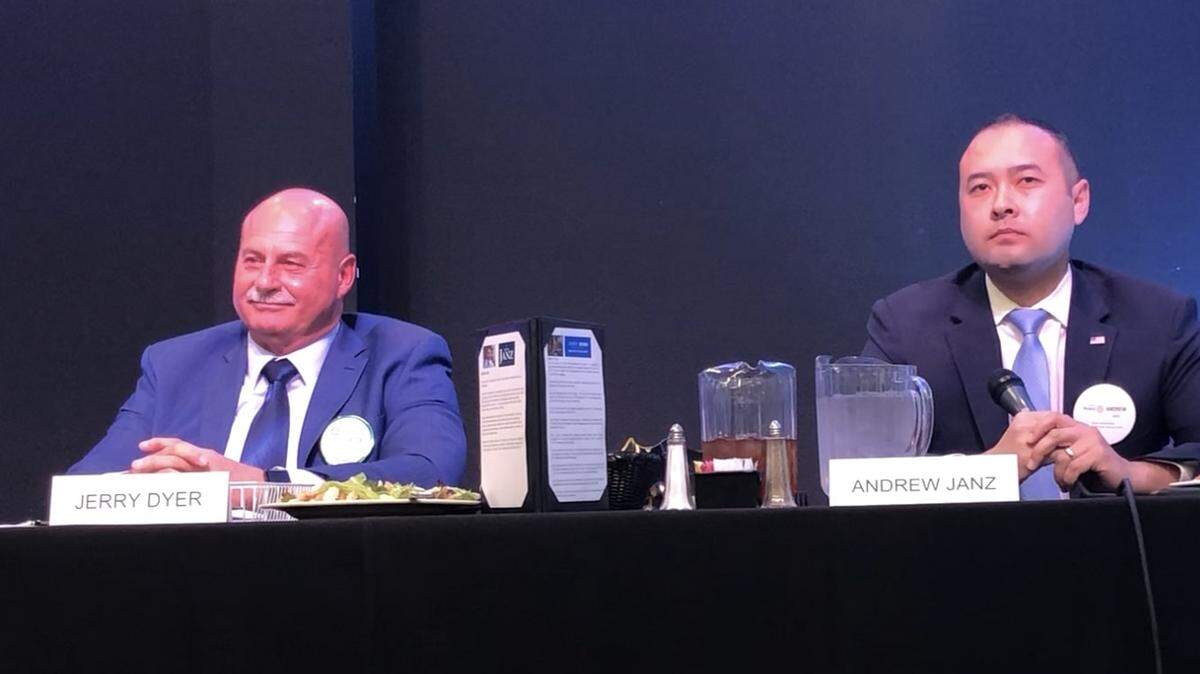 Fresno mayoral candidates Jerry Dyer, left, and Andrew Janz listen to a question on Monday, Feb. 10, 2020, at a Fresno Rotary Club forum.