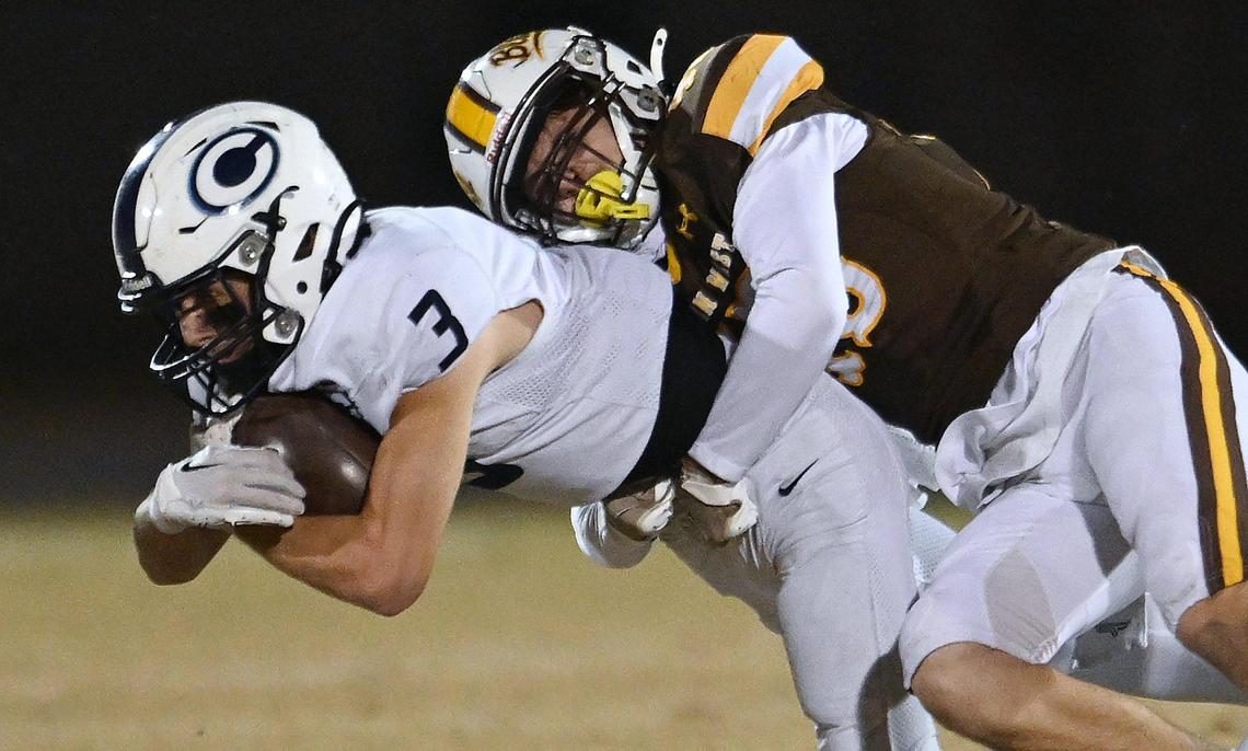 Central Valley Christian’s Micah Paden, left, is tackled by Golden West’s Michael Aguilar, right, in the D2 semifinal championship game Friday night, Nov. 22, 2024 in Visalia. CVC will face Bakersfield in next week’s final.