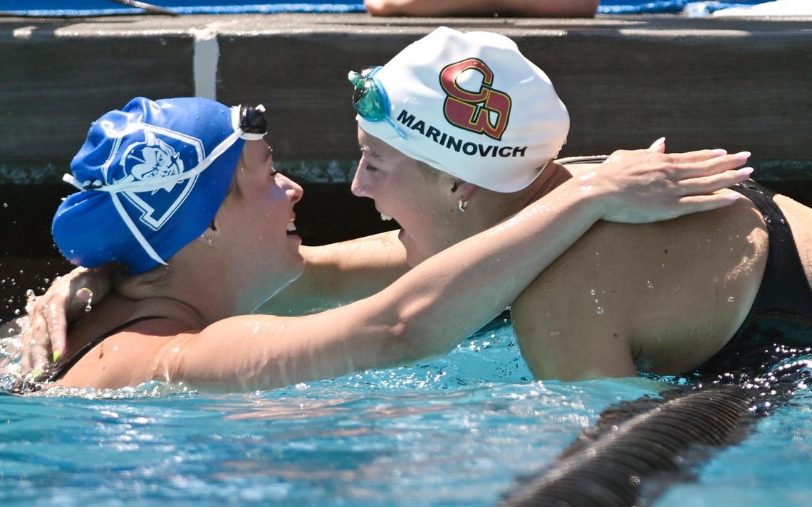 Clovis West’s Hannah Marinovich, right, congratulates Davis High’s Sarah Bennetts, left, after the 100 breaststroke at the CIF swimming and diving state championships on Saturday, May 13, 2023 in Fresno.