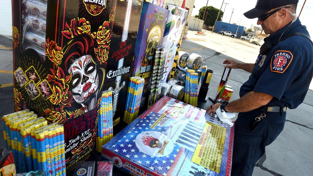Shane Brown, PIO for the Fresno Fire Department, arranges a tableful of illegal fireworks-thousands of dollars and just around 15% of what has been confiscated so far this year- for a press conference, June 23, held by Fresno Fire Chief Kerri Donis and Fresno Police chief Paco Balderrama to address the increase usage of illegal fireworks on the eve of the 4th of July holiday, and press the need for use of Safe & Sane fireworks. Balderrama said that an undercover task force will be using all relevant technology at their disposal, such as spot shooter, to find those using illegal fireworks.