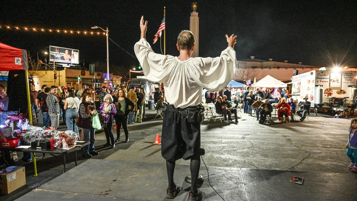 Tim Mooney performs a segment of his “Breakneck Comedy of Errors” show for attendees at the Rogue Festival Community Block Party in the Tower District on Thursday, March 4, 2022.