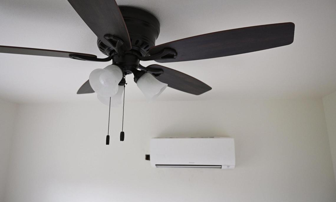 A wall-mounted ductless air conditioner is seen, background, coupled with a ceiling fan in a bedroom of a detached ADU unit Friday, Feb. 28, 2025 in Madera.