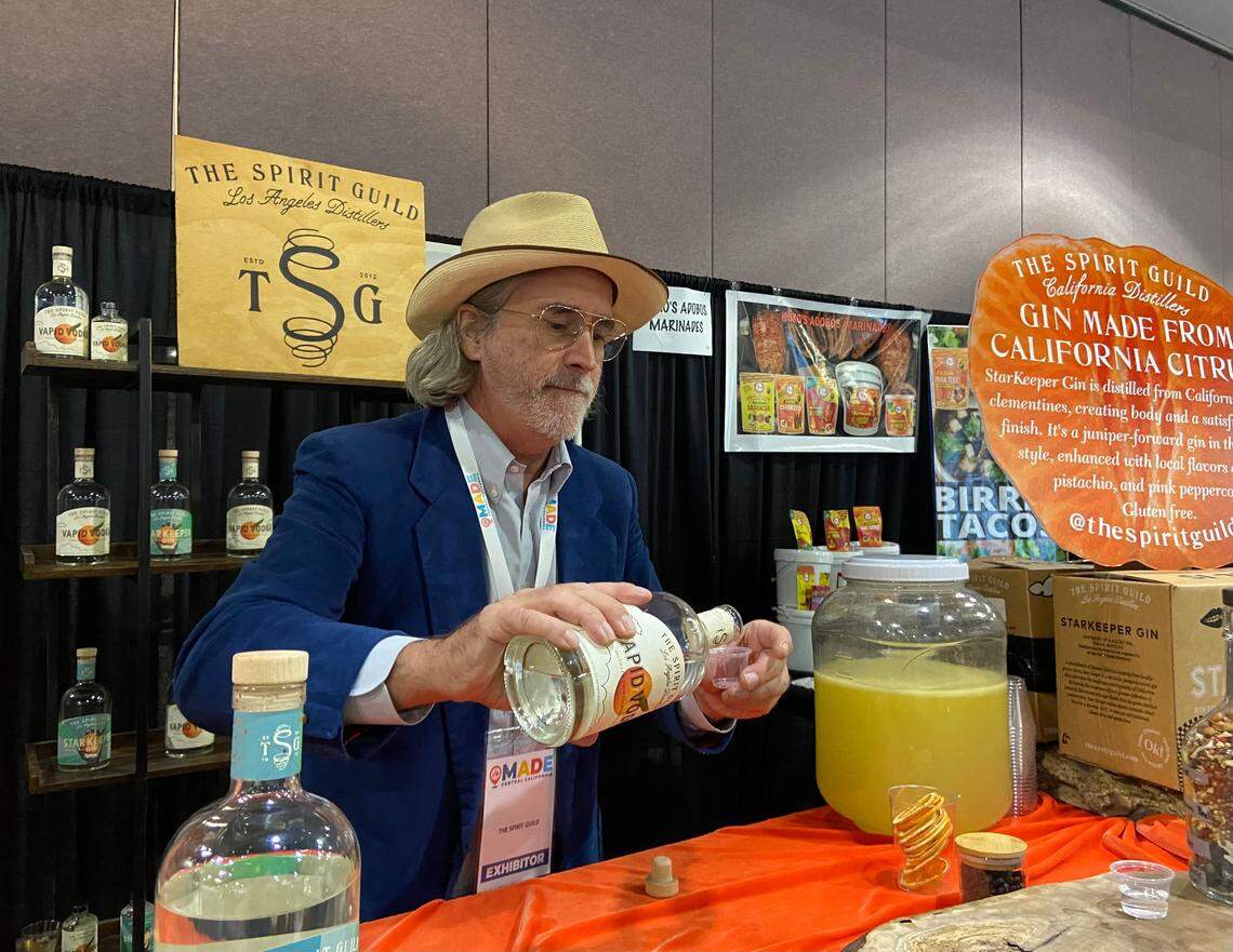 Miller Duvall, president of The Spirit Guild, prepares samples of gin and vodka made with citrus fruit. The Los Angeles distillery, which is looking to move to the Fresno area, was at the MADE Central California show.
