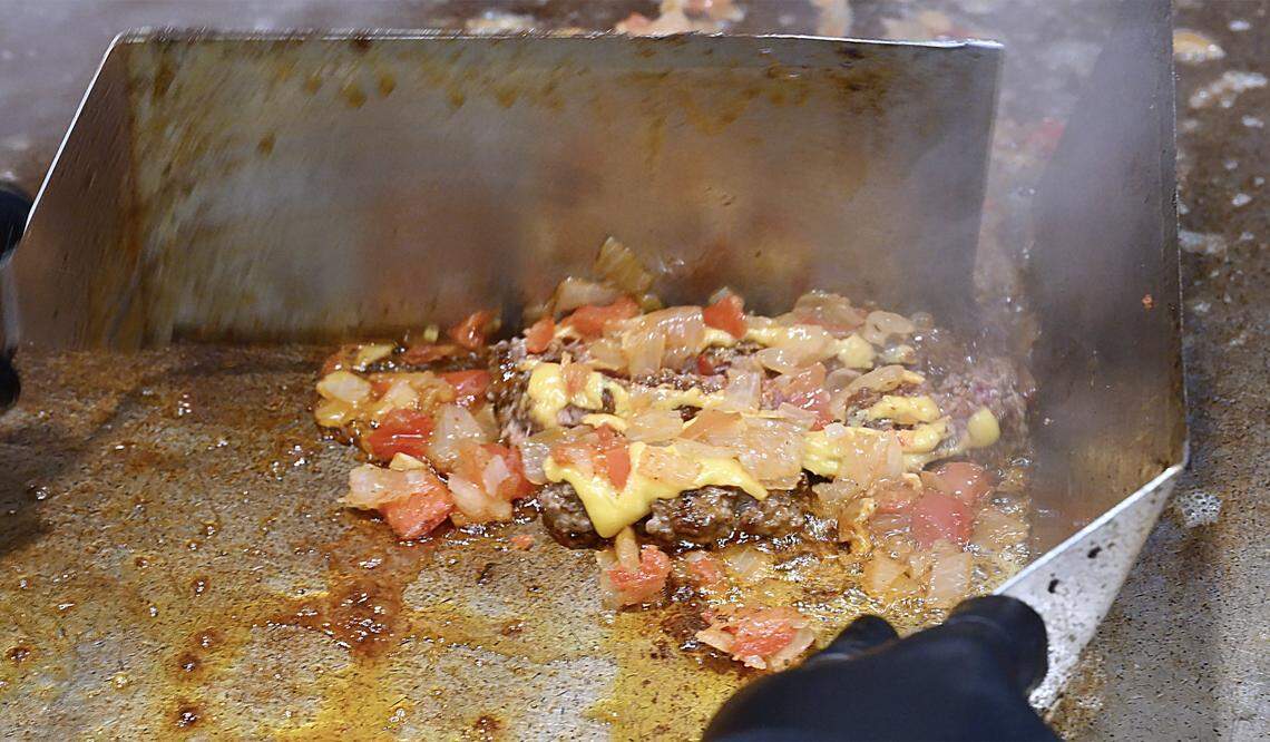 A chopped cheese sandwich is chopped with spatulas at Chop Cheese Bodega, Monday, Jan. 12, 2026 in Fresno.