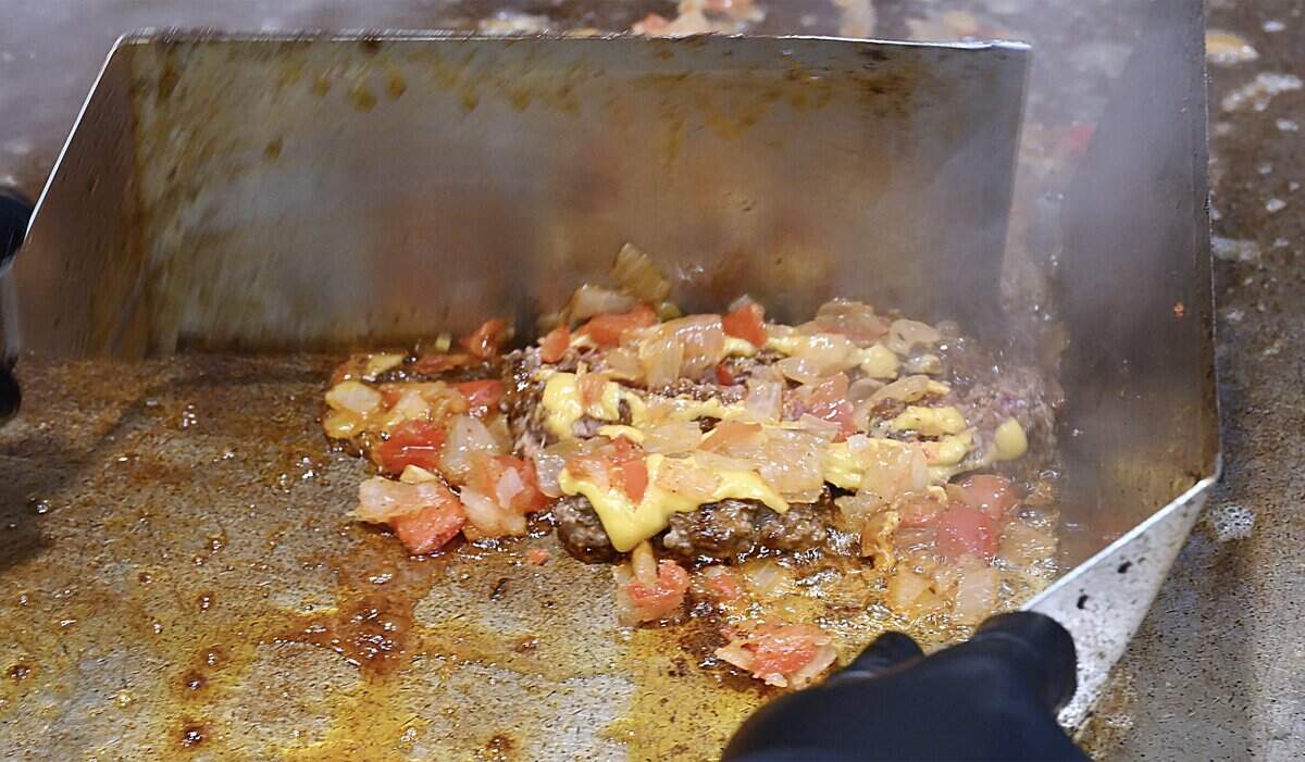 A chopped cheese sandwich is chopped with spatulas at Chop Cheese Bodega, Monday, Jan. 12, 2026 in Fresno.