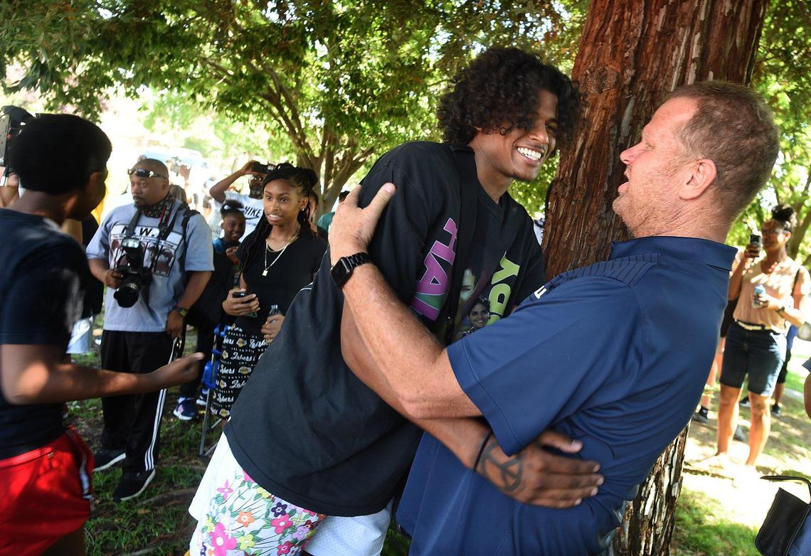Jalen Green hugs San Joaquin Memorial coach Brad Roznovsky before the dedication of the basketball court, he renovated, dubbed “The Cage,” at Koligian Park, July 17, 2021. It has been a dream of his to give back to his hometown by renovating the court that ignited his love for the game.