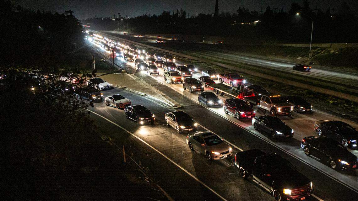 Vehicles stopped at a standstill on Highway 41 at the Shaw Avenue overpass as officers searched for a man who ran on the freeway Monday, Jan. 31, 2022.