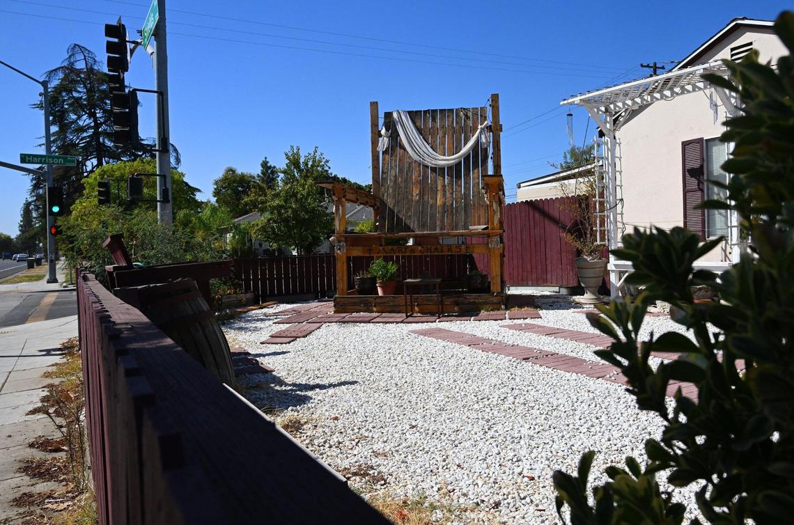 A large wooden chair sits in Robert Sandoval’s front yard along Shields Avenue at Harrison Avenue. Robert said he constructed the chair in 2021 to memorialize his wife Mary Ann who died in a car crash in 2015. Photographed Sept. 26, 2024 in Fresno