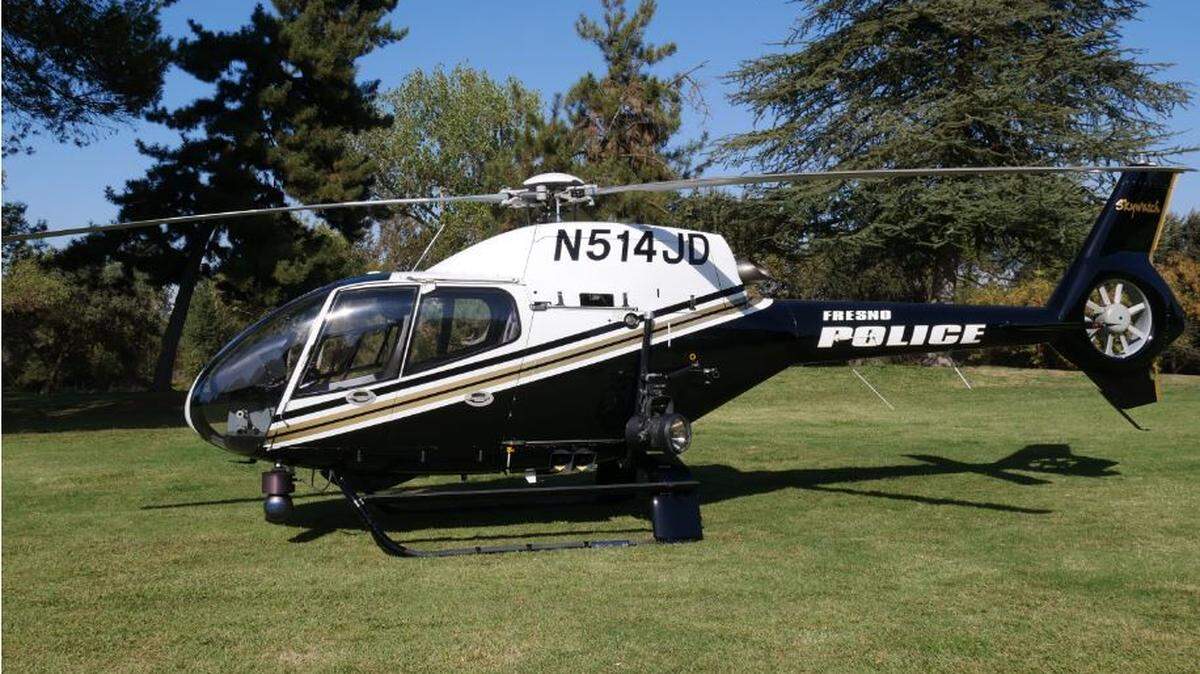 The pilot of the Fresno police helicopter directed officers to a home after he was targeted by a laser Tuesday night.