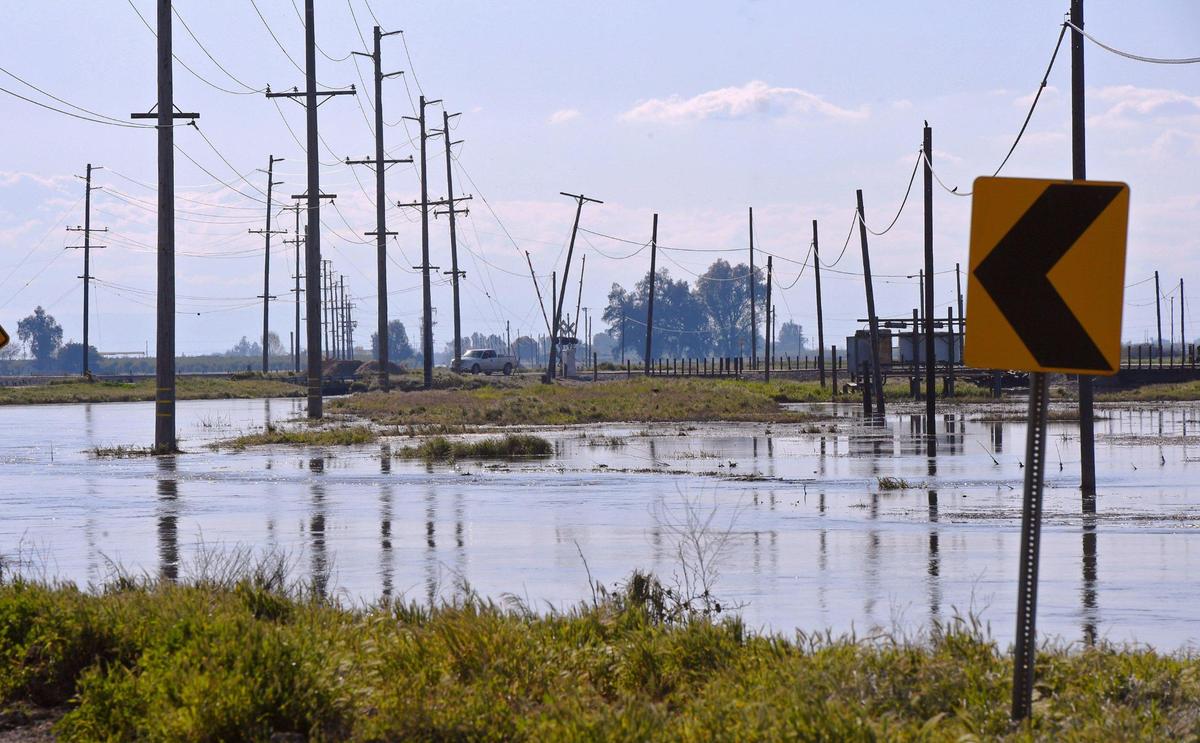 Runoff from recent storms floods cropland and overflows onto roadways and dairy land south of Hanford in Kings County, CA, on Friday, March 31, 2023. Forecasters and state water officials said even more flooding could result when a record snowpack in the southern Sierra Nevada begins melting in earnest this spring and summer.