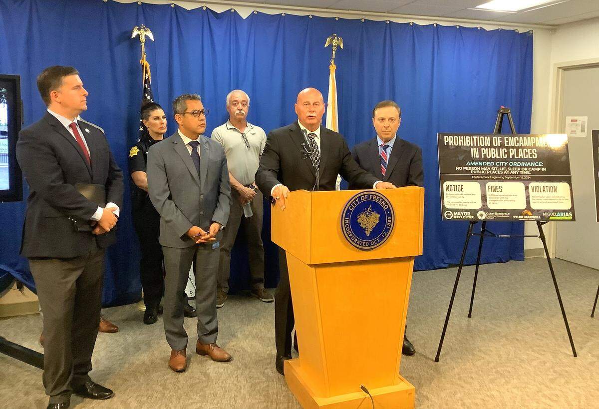 Fresno Mayor Jerry Dyer answers questions at a press conference about proposed amendments to city ordinances to camping or sleeping on sidewalks or other public spaces a misdemeanor crime, with offenders subject to fines and arrest. He was joined by, from left, City Councilmember Tyler Maxwell, Police Chief Mindy Casto, Councilmember Miguel Arias, business owner Edward Noriego, and Councilmember Garry Bredefeld.