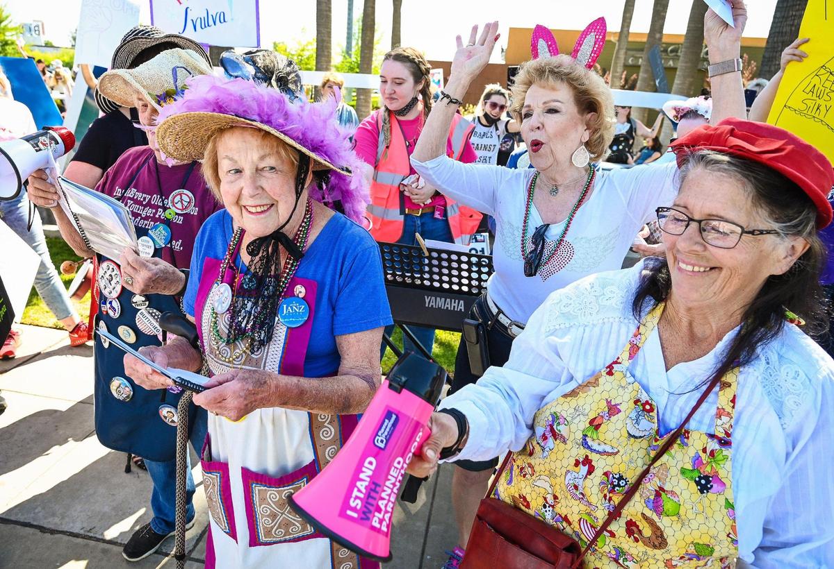 Members of the Raging Grannies sing while joining protesters near the River Park shopping center in Fresno during a rally in support of Roe v. Wade on Saturday, May 14, 2022.