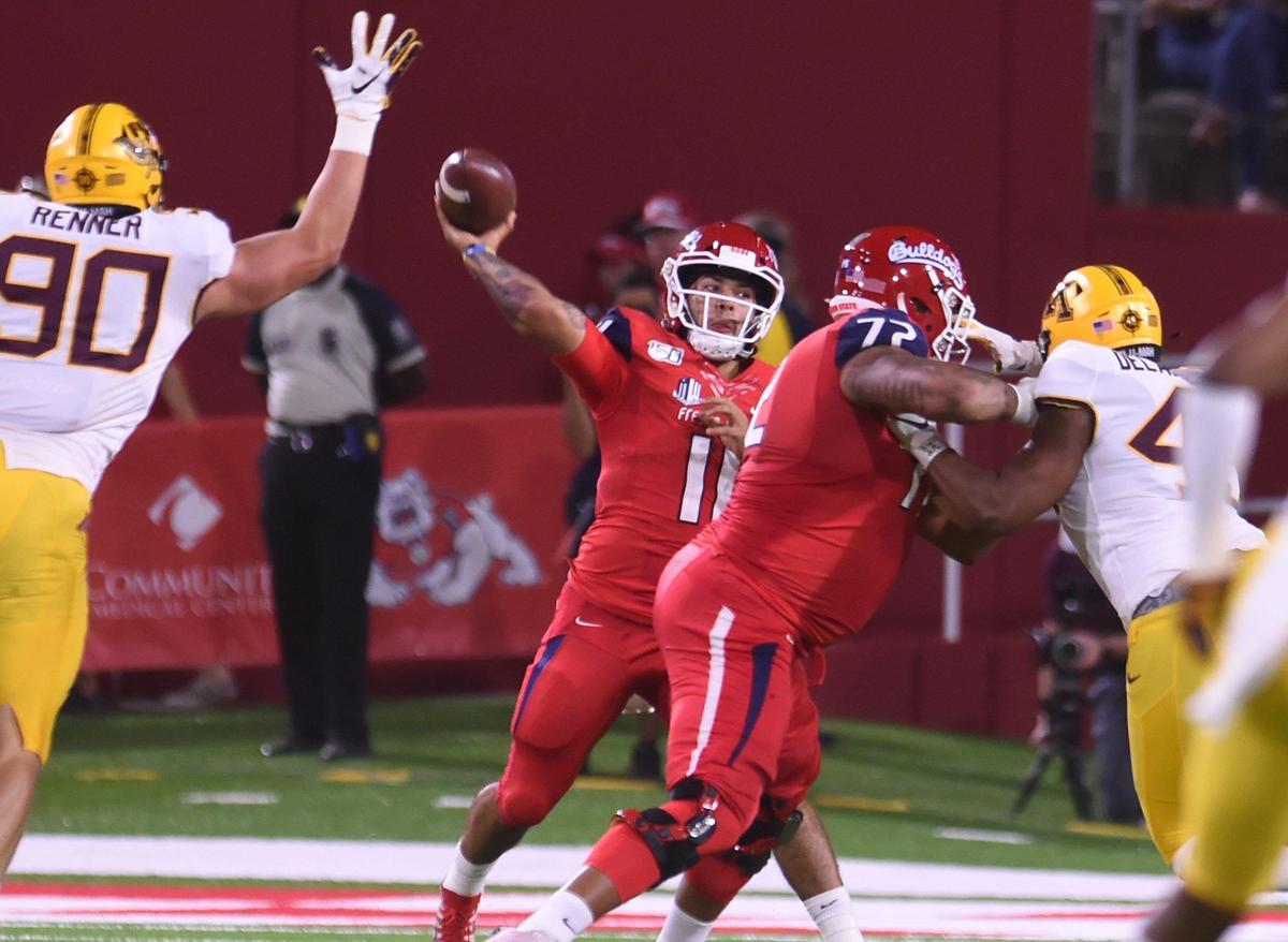 Fresno State quarterback Jorge Reyna, center, passes against Minnesota Saturday, Sept. 7, 2019 in Fresno. Reyna completed 24 of 35 passes for 288 yards with three touchdowns, but had a pass intercepted in overtime that sealed the Bulldogs’ 38-35 loss to the Golden Gophers.