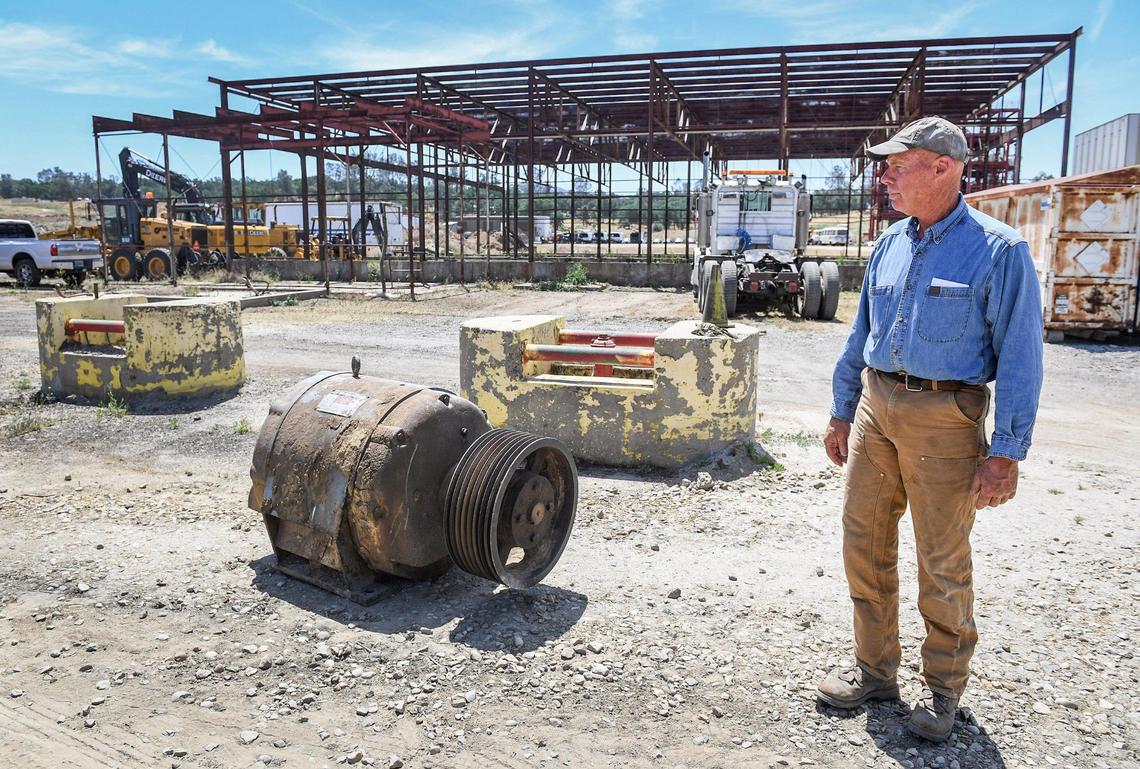 Kirk Ringgold stands near a giant motor that may be used in his anticipated sawmill operation on property he owns in Auberry, on Thursday, May 13, 2021.