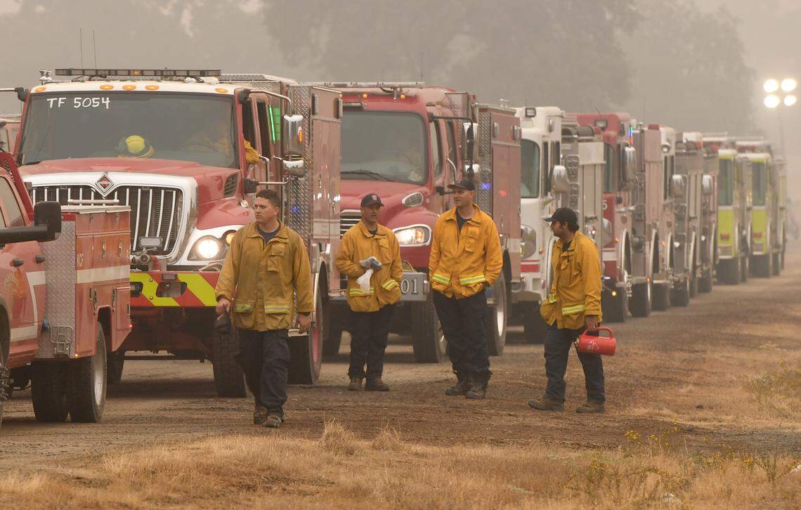 Fire crews wait in line with their trucks at the fueling station set up at at the base of the highway 168 four-lane, Sept. 12, 2020.