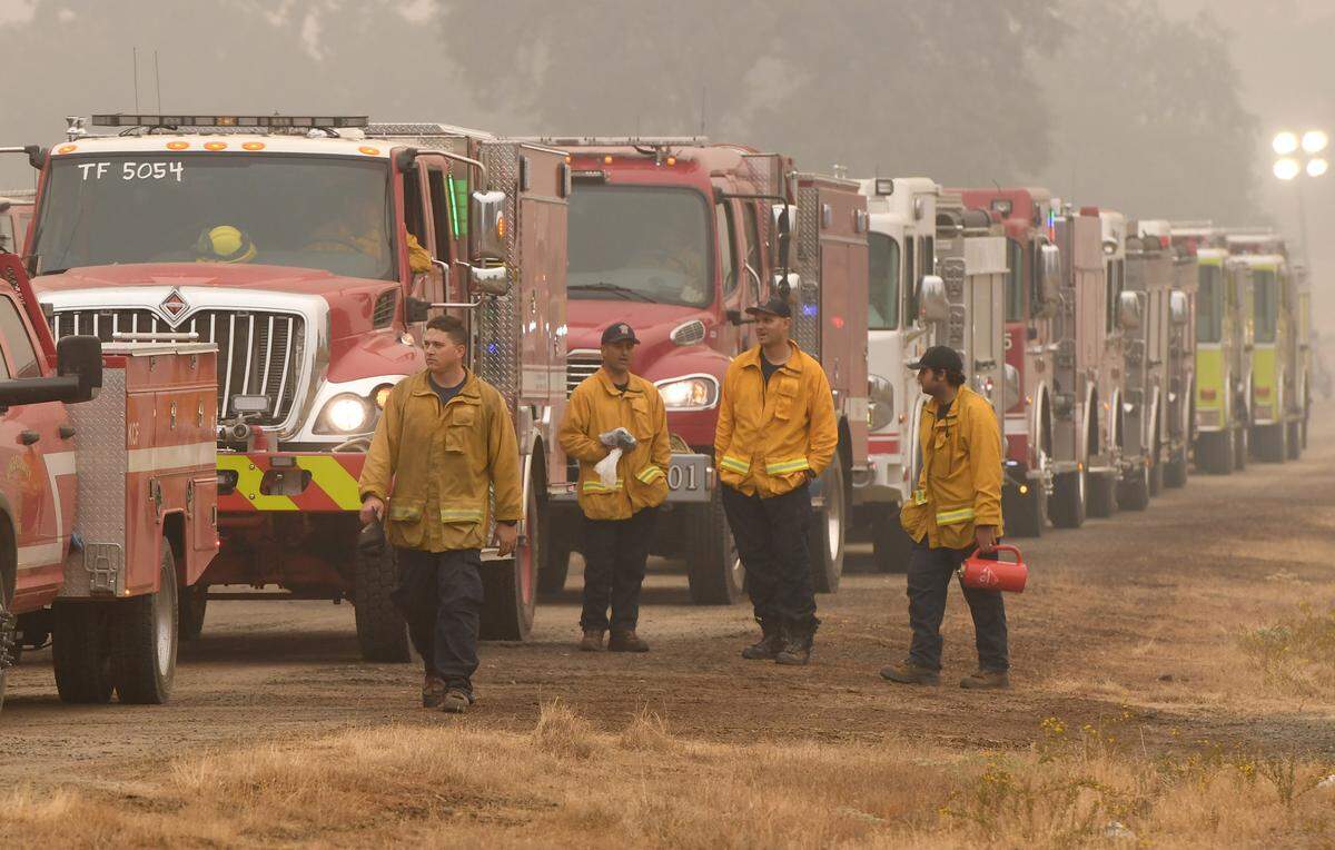 Fire crews wait in line with their trucks at the fueling station set up at at the base of the highway 168 four-lane, Sept. 12, 2020.