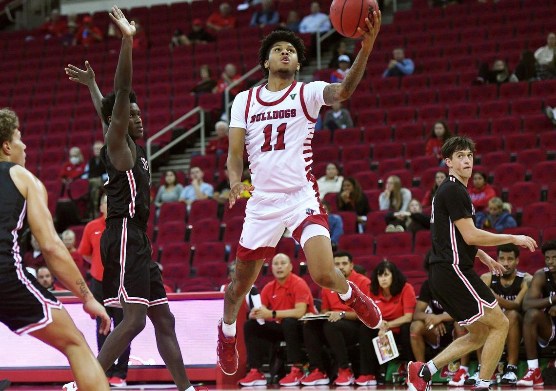 Fresno State Donavan Yap, center, goes up with Stanislaus State’s Jeremiah Jones, left, and Will Pallesi, right, in an exhibition game Wednesday, Nov. 3, 2021 in Fresno. Fresno State led 46-21 at halftime.