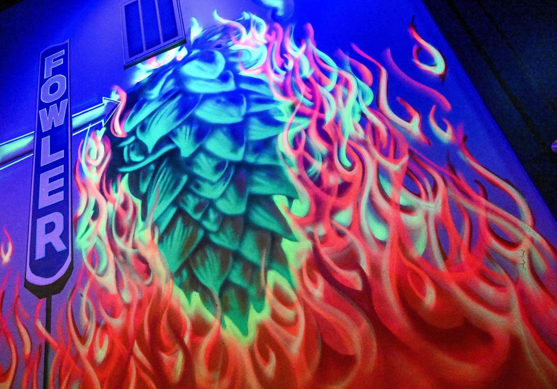 A colorful mural featuring a giant hop flower and flames covers a wall at Station 48, a beer and wine taproom that is opening inside an old fire station in downtown Fowler.