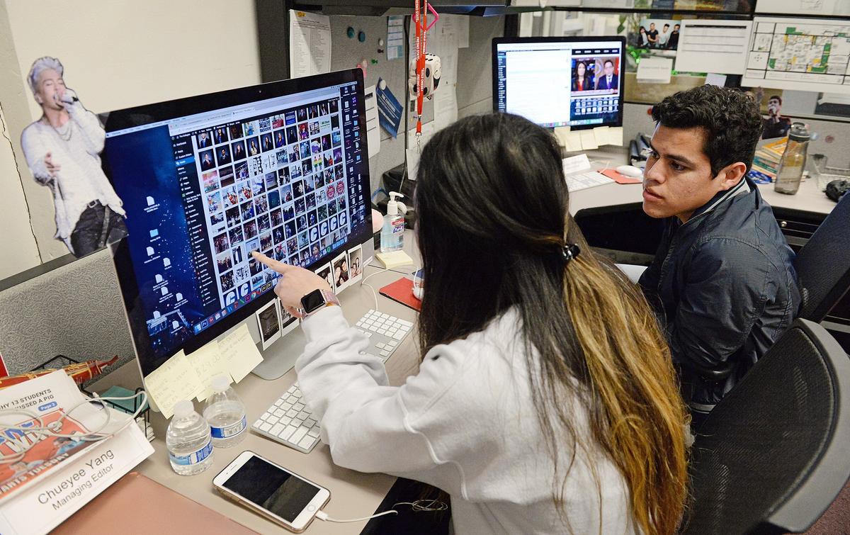 Cresencio Rodriguez-Delgado, editor-in-chief of the Fresno State student newspaper, works with managing editor Chueyee Yang in The Collegian newsroom at Fresno State while producing the next day's issue, on Tuesday, March 21, 2018. Rodriguez-Delgado is a DACA recipient, or Dreamer, as are five of his 10 siblings.