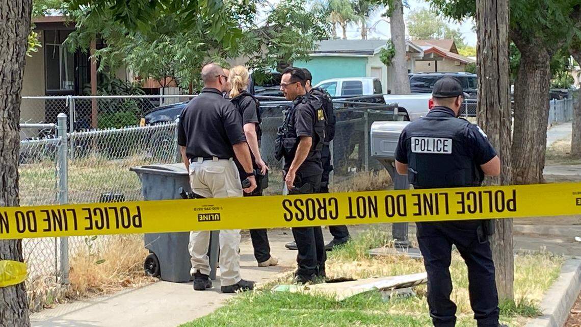 Officers investigate the block where two people were shot Thursday, June 8, 2023, in southwest Fresno, police said.
