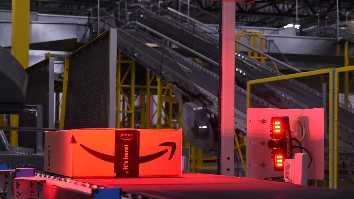 A box is carried along through the weighing process at the Amazon FAT1 fulfillment center Tuesday, Jan. 7, 2019 south of Fresno.