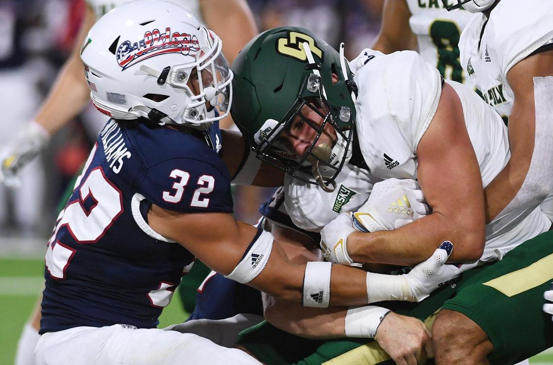 Fresno State safety Evan Williams, left, helps bring down Cal Poly’s Giancarlo Woods during the Bulldogs’ 63-10 victory over the Mustangs, Saturday, Sept. 11, 2021 in Fresno.