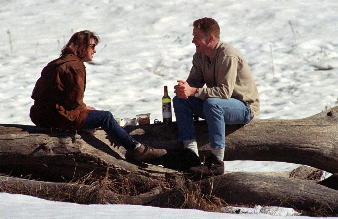 Lori Chandler, left, and Matt Garrett, both of Fresno, use a log for a table as they picnic in the snow at El Capitan Meadow in Yosemite National Park on Feb. 10, 1995.