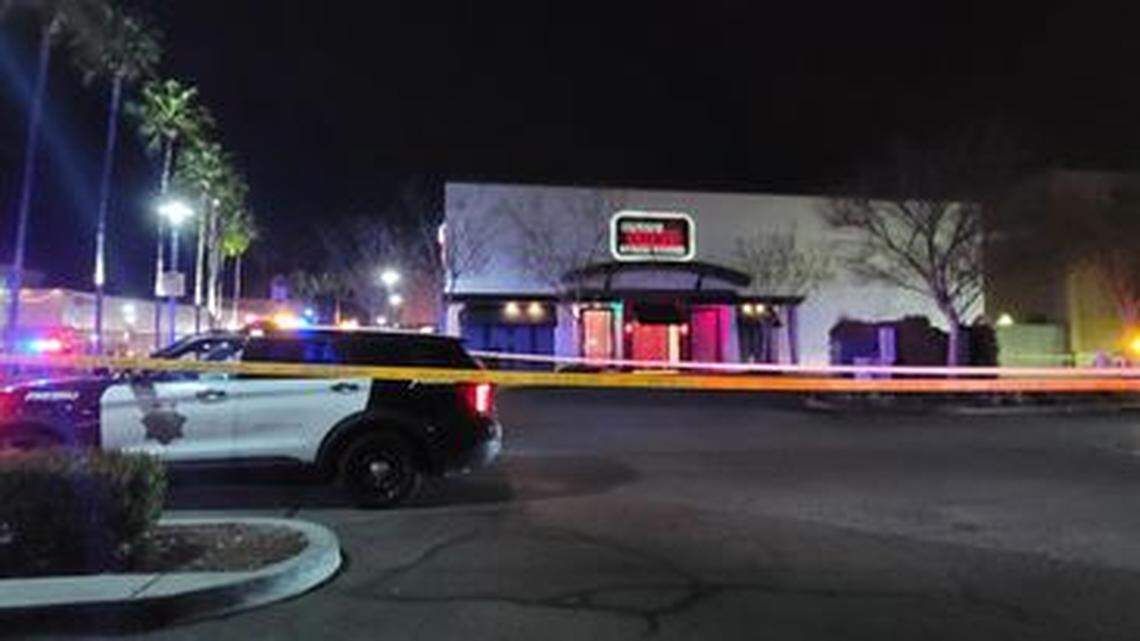 Police tape off the parking lot of Ruth’s Chris Steak House in River Park after a man was found with multiple gunshot wounds on Monday, Feb. 28, 2022.