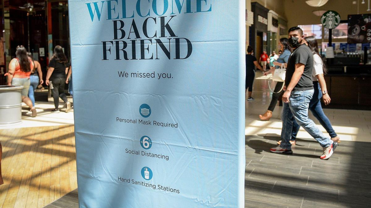 A sign welcoming customers back to Fashion Fair mall displays guidelines for visiting, including wearing masks, maintaining social distancing and using hand sanitizing stations, on Tuesday, May 26, 2020. The mall opened for the first time since late March due to the coronavirus pandemic.