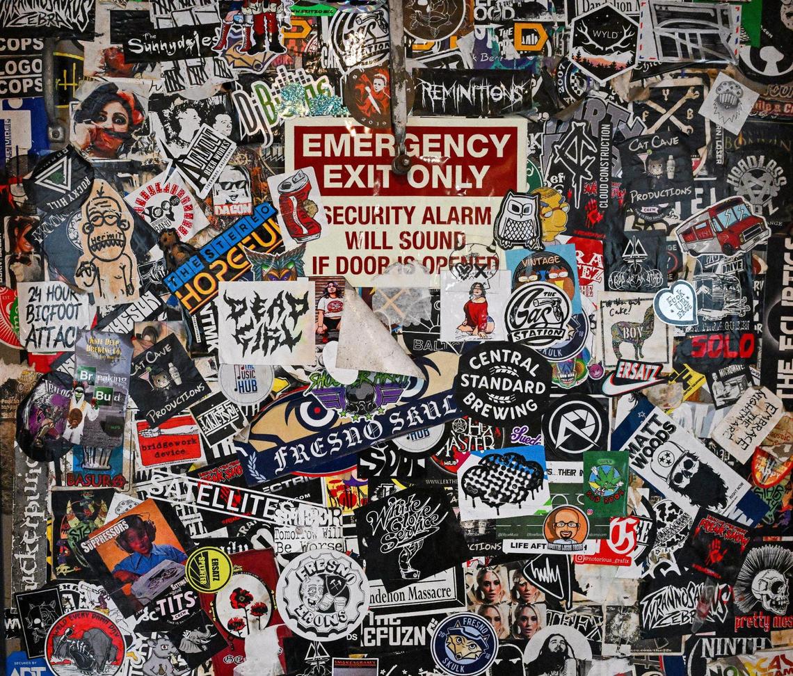 Various stickers from local bands, beers and other groups still cover the back door at what is now Summer Fox, located in the old Club Fred and Audie’s Olympic in the Van Ness Village area of the Tower District in Fresno.