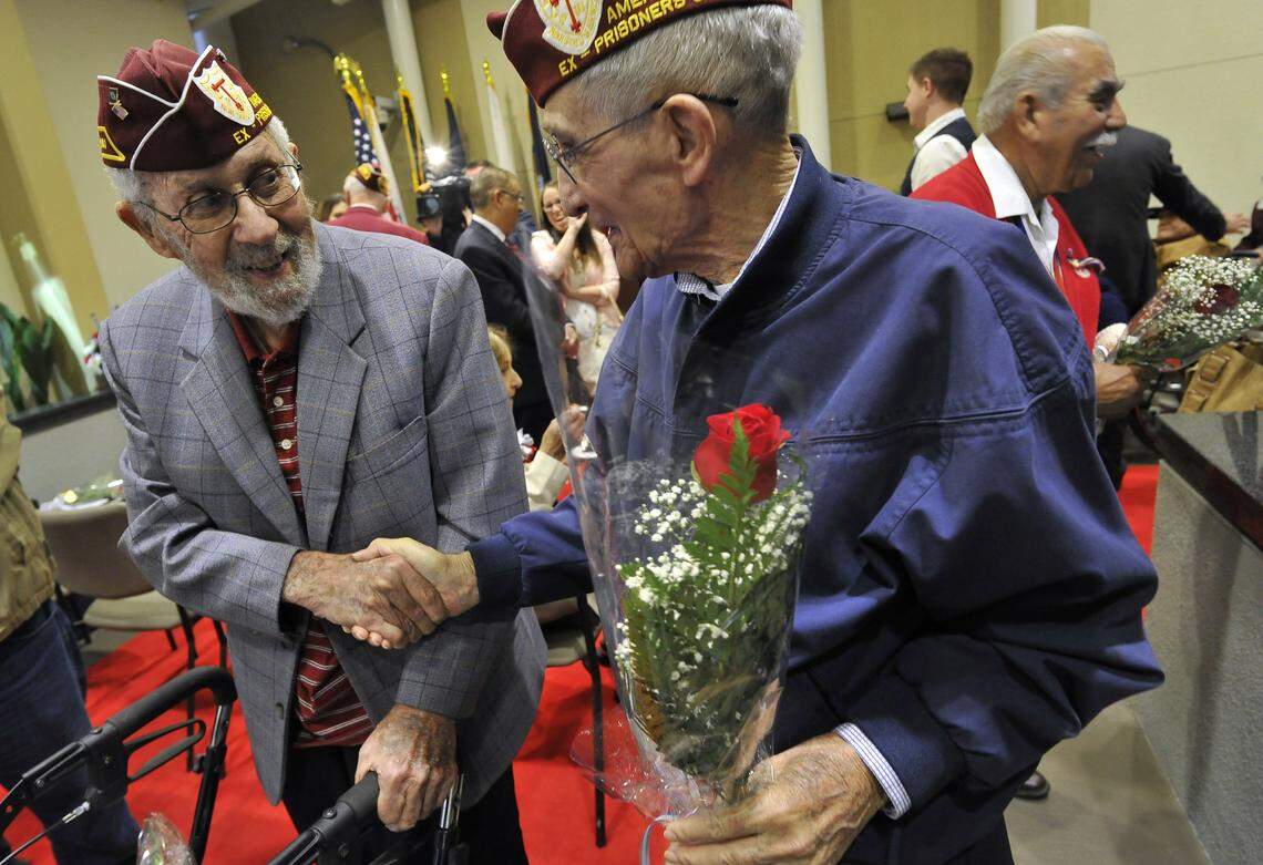 World War II POW veterans, Jack Schwartz, left, and Earl Miles, right, reminisce after a 2015 ceremony to honor POWs at VA Central California Health Care System in central Fresno.