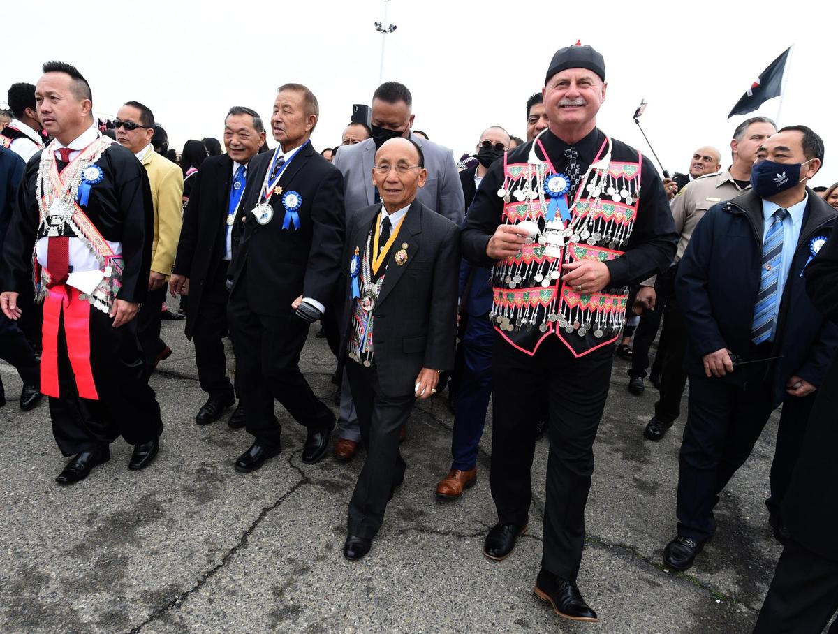 Fresno Mayor Jerry Dyer marches along with dignitaries from the Hmong community during opening day parade ushering in the Hmong New Year celebration at the Fresno Fairgrounds, Thursday morning, December 30, 2021.