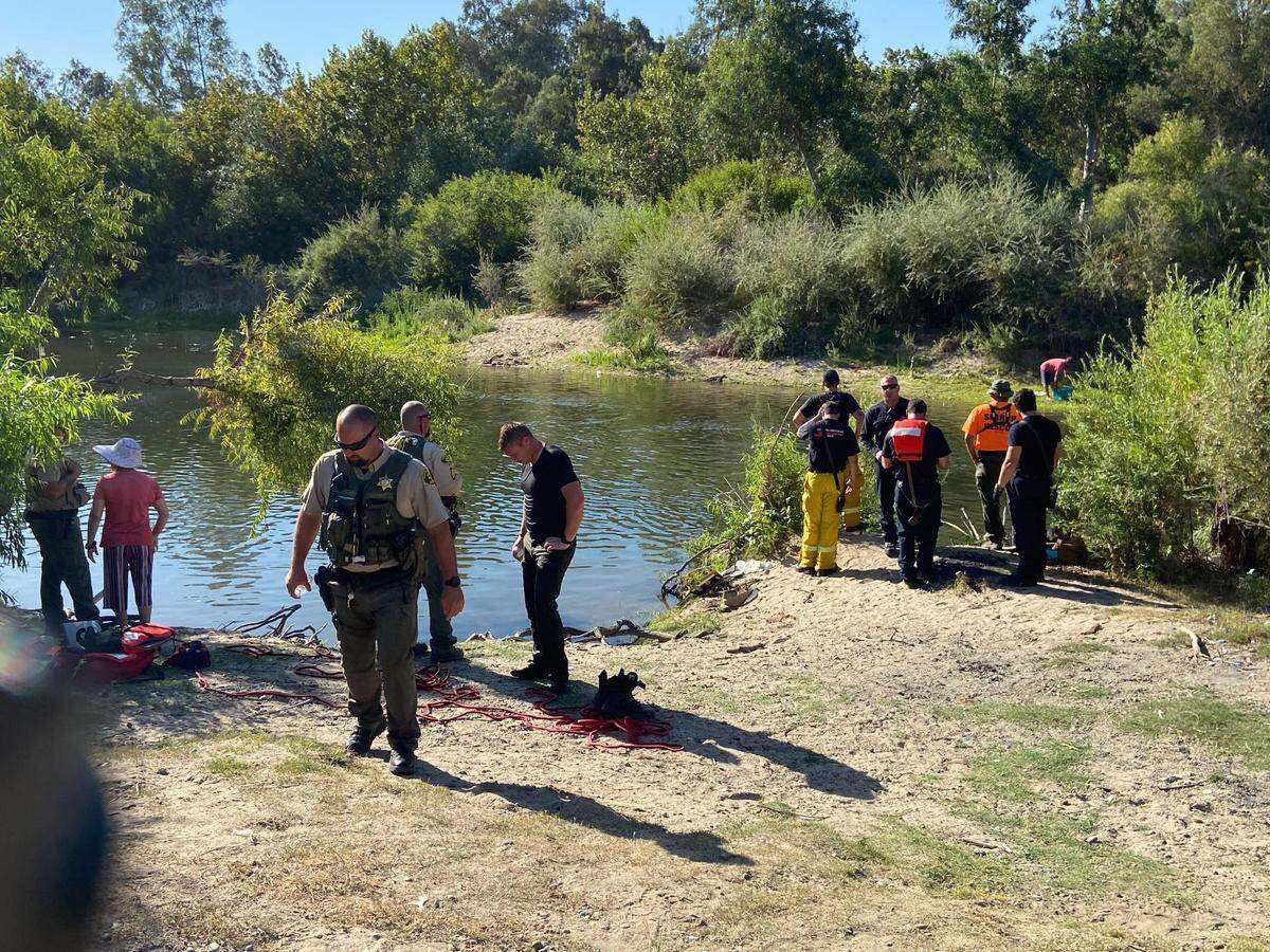 Search crews gather Sunday, Aug. 21, 2022, at Skaggs Bridge Park after a woman disappeared under the waters of the San Joaquin River.