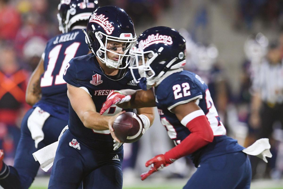 Fresno State quarterback Jake Haener, left, hands off to Malik Sherrod, right, in the game against San Diego State Saturday, Oct. 29, 2022 in Fresno.