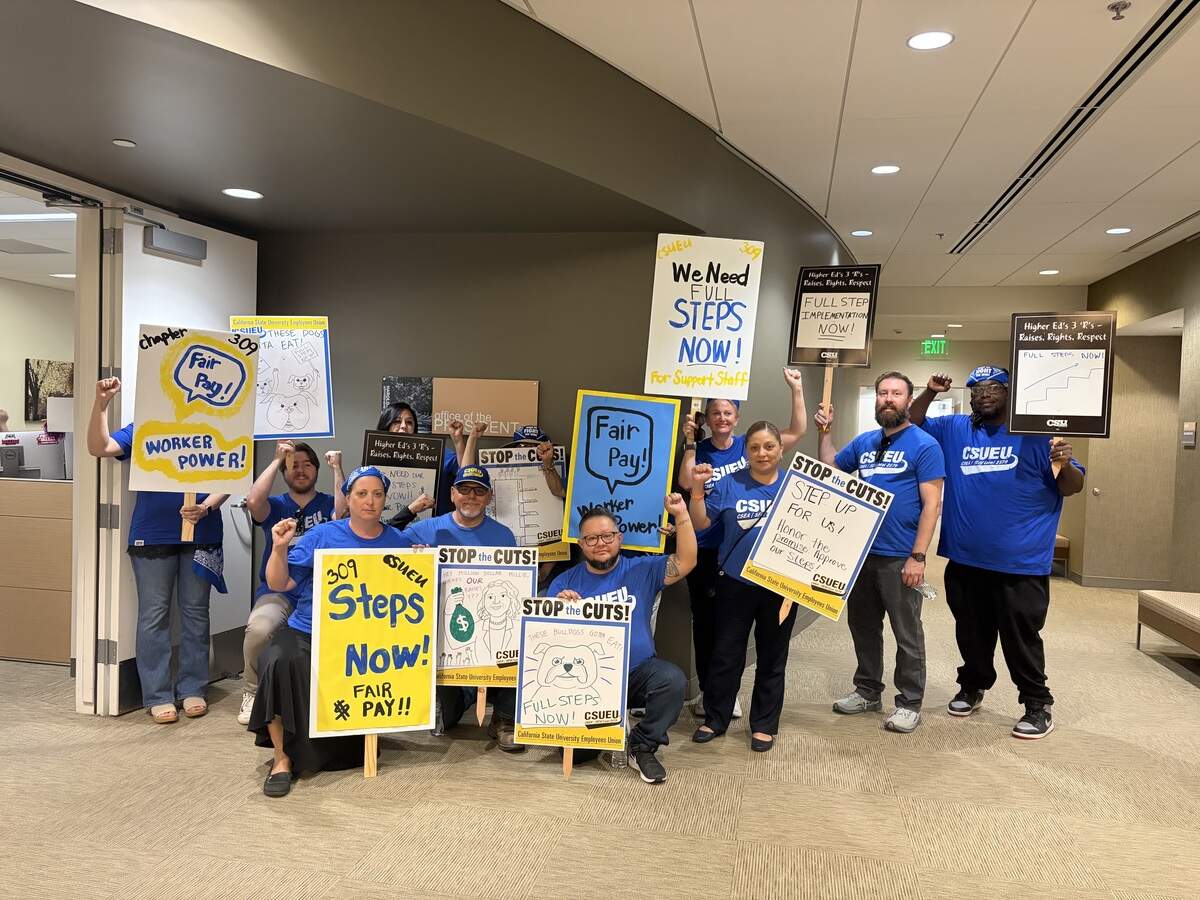 The Fresno State chapter of the CSU Employees Union poses outside of the university president’s office