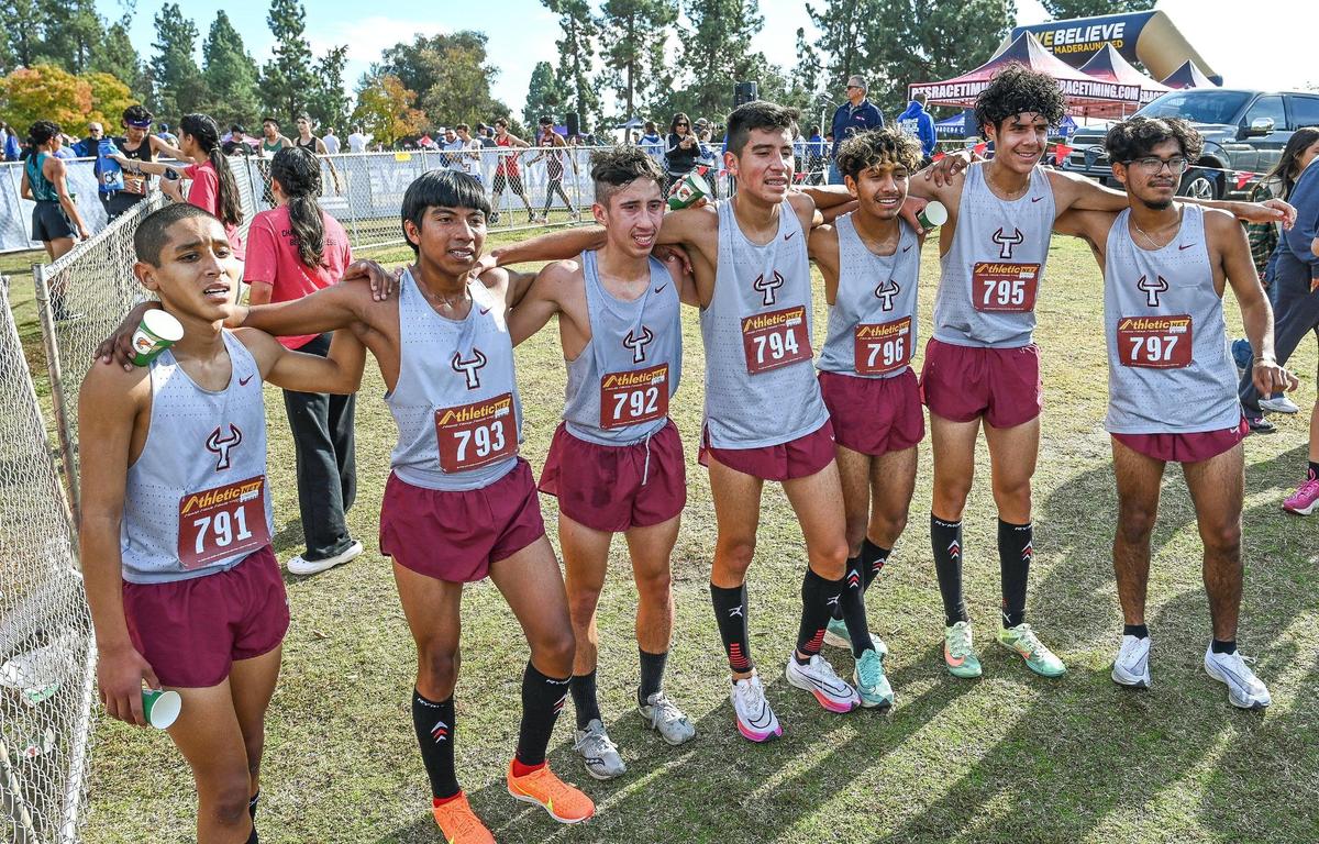 Members of the Matilda Torres High boys cross country team including first-place individual finisher Benjamin Fernandez, left, gather for a photo after their Central Section boys Division IV cross country race at Woodward Park in Fresno on Thursday, Nov. 17, 2022. The team finished first overall.