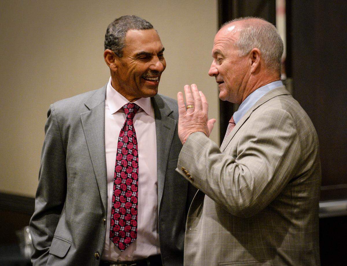 Arizona State head coach Herm Edwards, left, and Fresno State head coach Jeff Tedford chat before the start of a Las Vegas Bowl news conference at the Hard Rock Cafe & Casino in Las Vegas on Friday, Dec. 14, 2018. The Bulldogs and Sun Devils play Saturday at Sam Boyd Stadium.