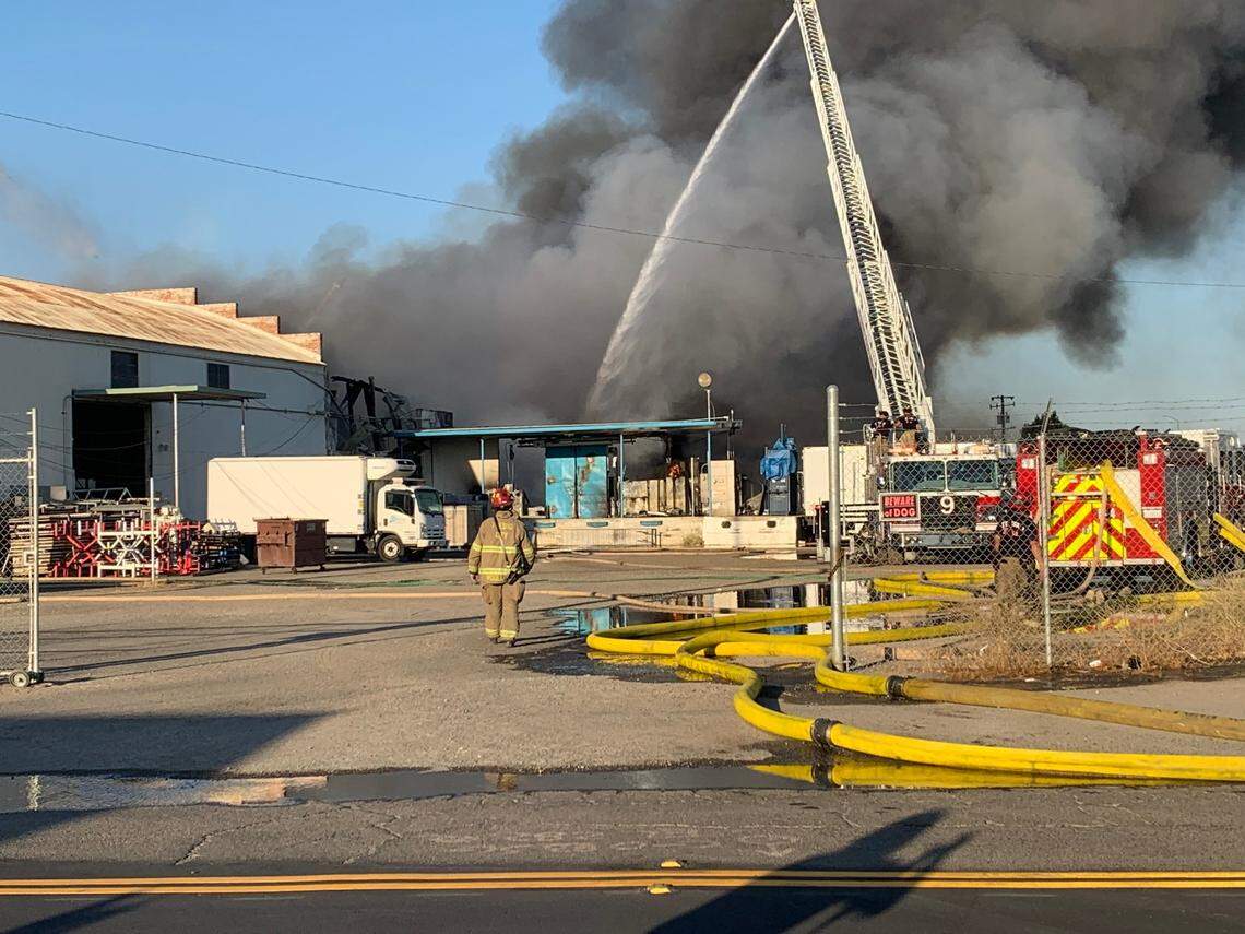 Firefighters battle a blaze at a warehouse near Roeding Park on Saturday, June 26, 2021, in Fresno, California.