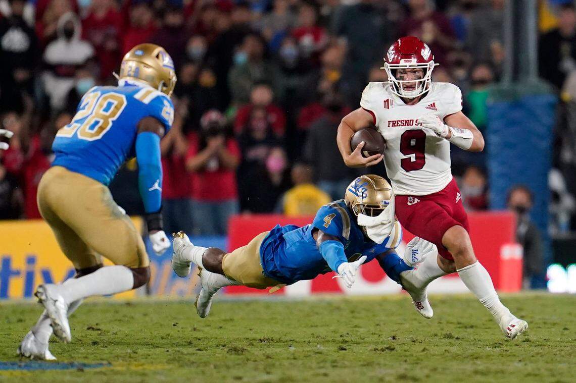 Fresno State quarterback Jake Haener (9) runs past UCLA defensive back Stephan Blaylock (4) during the second half of the Bulldogs’ 40-37 victory over the Bruins Saturday, Sept. 19, 2021, at the Rose Bowl in Pasadena