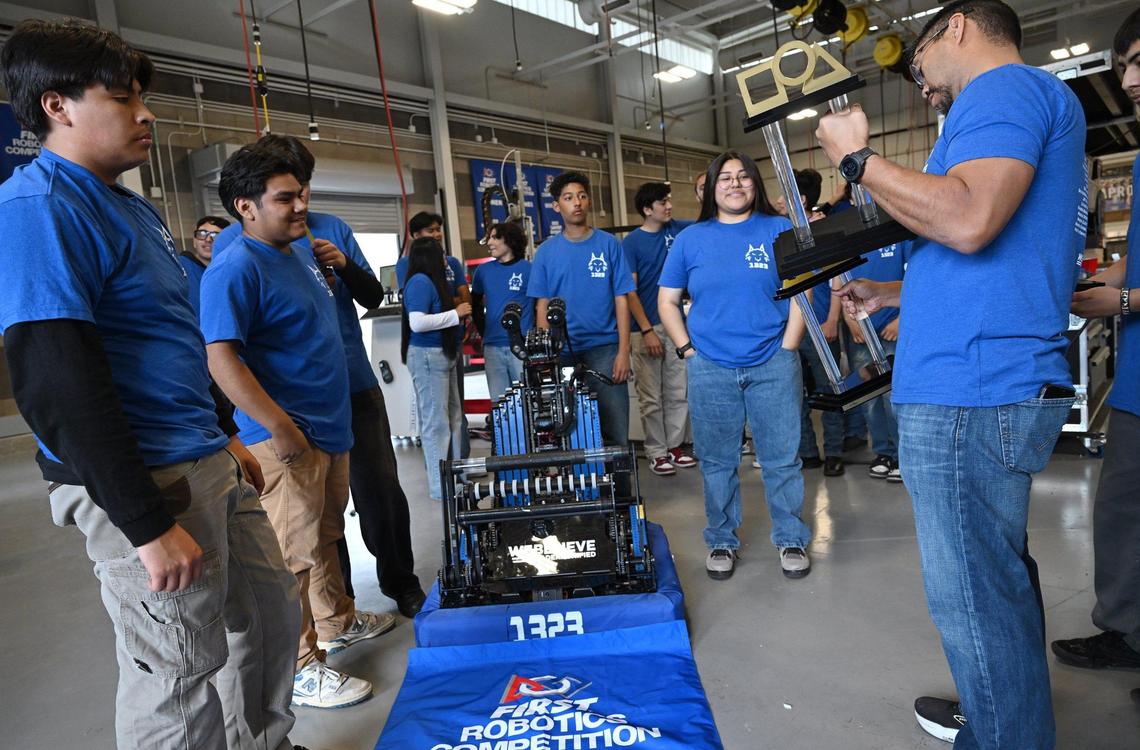 Vern ValMonte, right, Madera Unified’s MadTown 1323 Robotics team, holds the trophy after MadTown 1323 won its third World Championship at the 2025 international competition. Photographed Tuesday, May 13, 2025 in Madera.