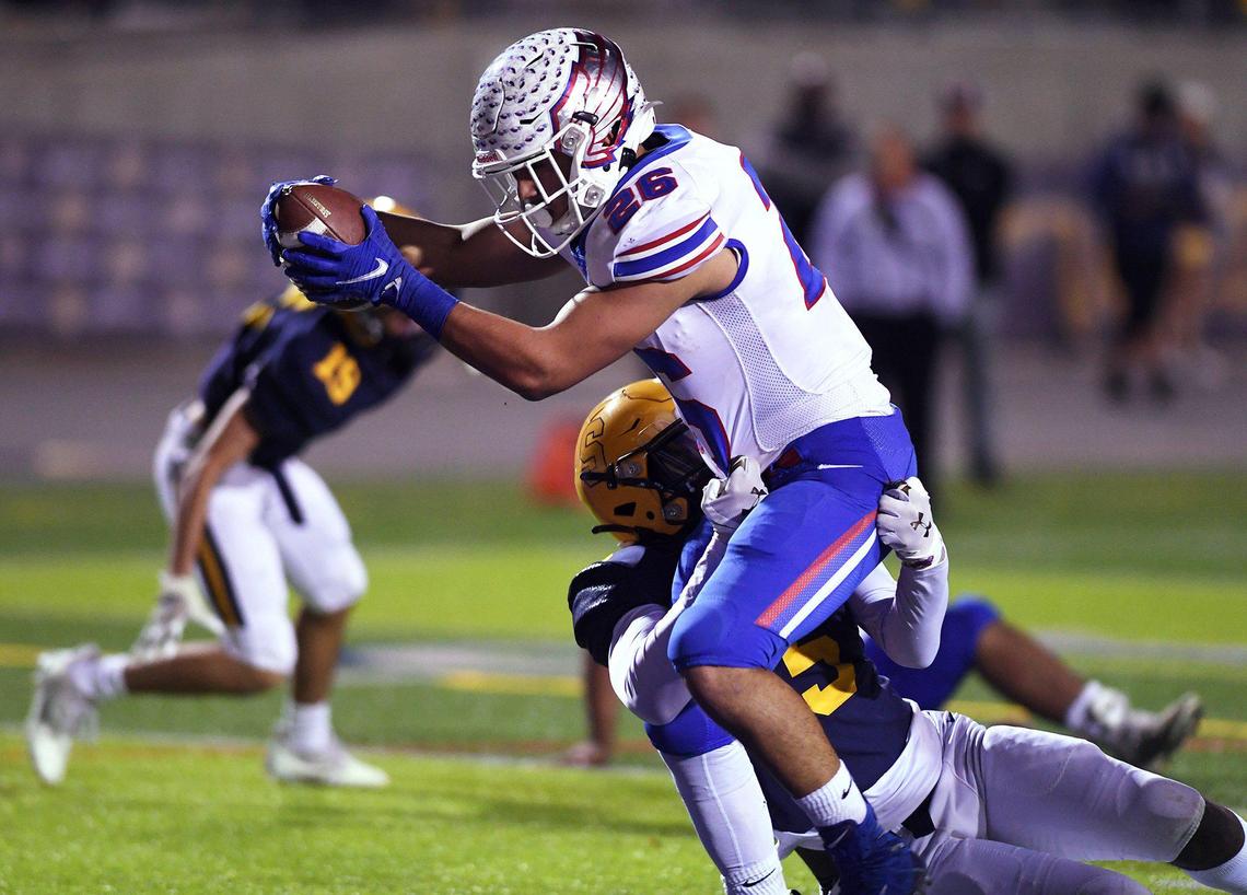 Firebaugh’s Danny Olivera, left, extends the ball for the touchdown with Sunnyside’s Kennedy Lacy tackling from behind in a Central Section Division III playoff game Thursday night, Nov. 4, 2021 in Fresno.