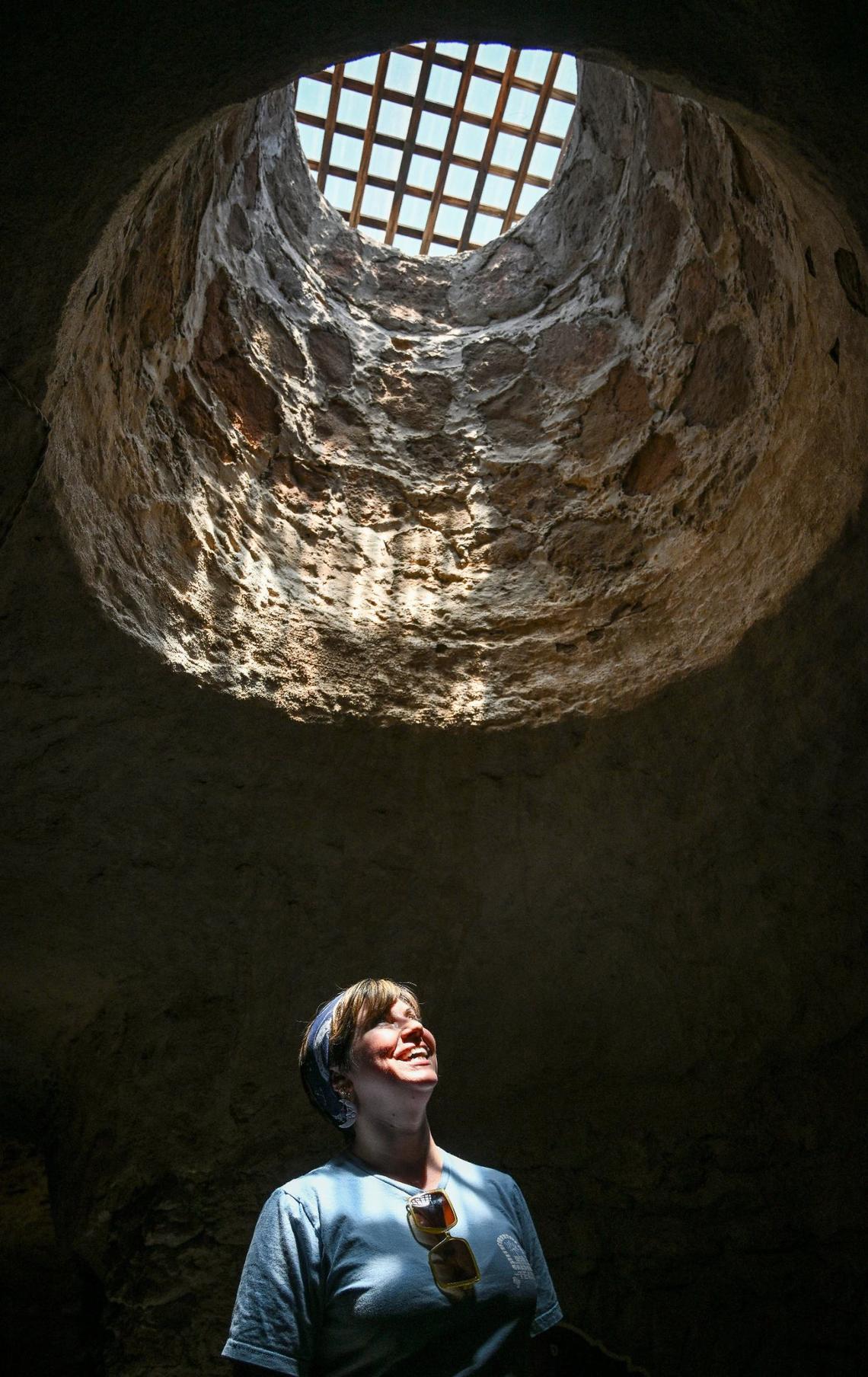 Shera Franzman, director of operations at the Forestiere Underground Gardens in Fresno, keeps cool below ground while looking up into one of the gardens many skylight openings on Monday, July 22, 2024.