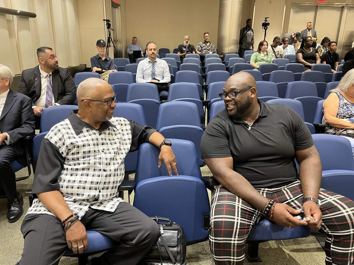 Pastors B.T. Lewis, left, and DJ Criner chat before the June 18, 2026, Fresno City Council meeting.