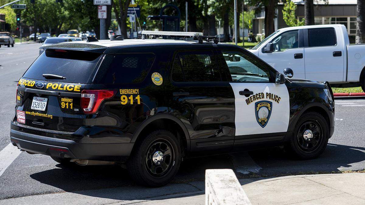 A Merced Police Department patrol vehicle turns onto West 22nd Street in Merced, Calif., on Tuesday, April 12, 2022.