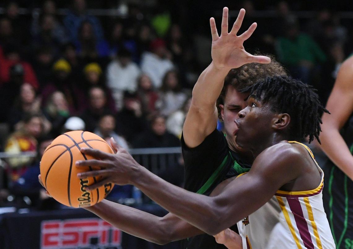 Clovis West’s Marshel Sanders, foreground drives past St. Joseph’s Luis Marin in the Central Section boys Division I basketball championship Saturday, Feb. 25, 2023 in Clovis. St. Joseph won the championship beating Clovis West with a final score of 74-58.