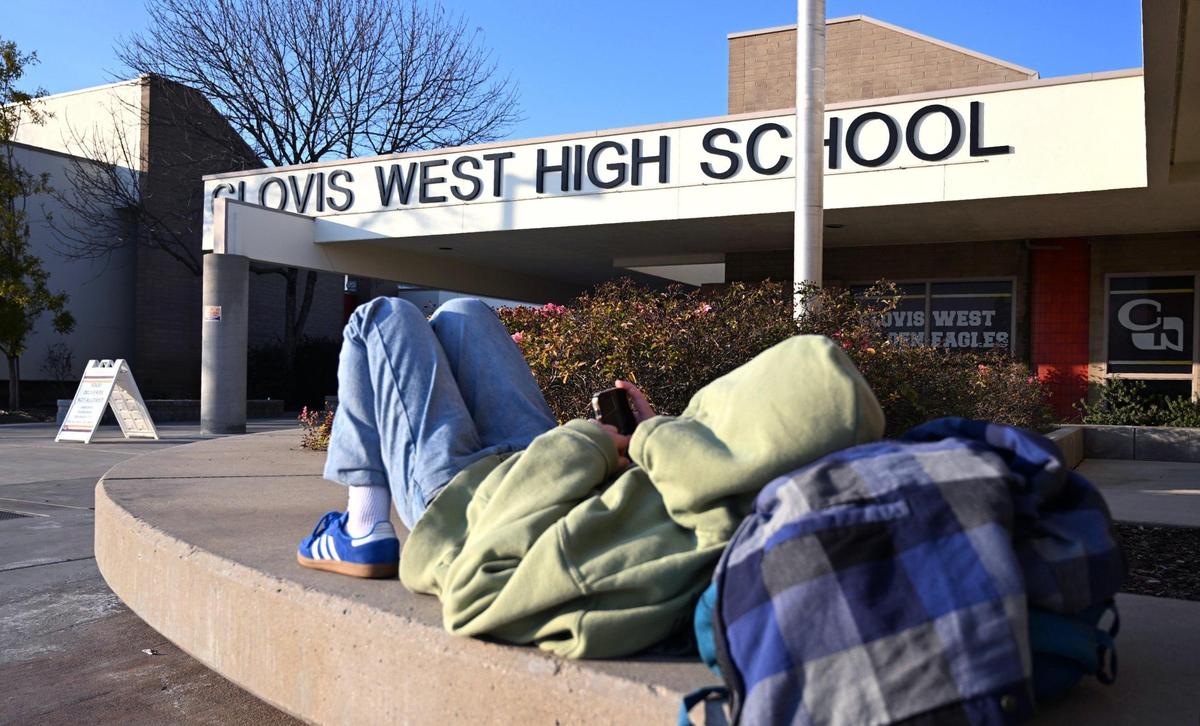 A student waits outside Clovis West High School Thursday afternoon, Jan. 30, 2025 in Fresno.